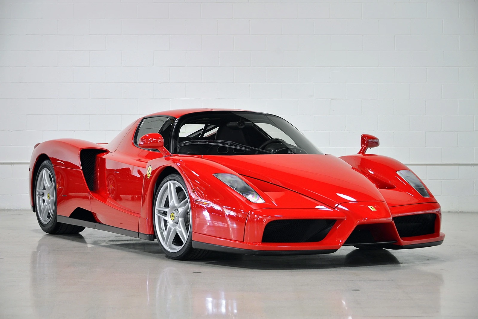 Close-up photo of an Enzo Ferrari, showcasing its sleek design, aerodynamic features, and iconic Ferrari emblem.