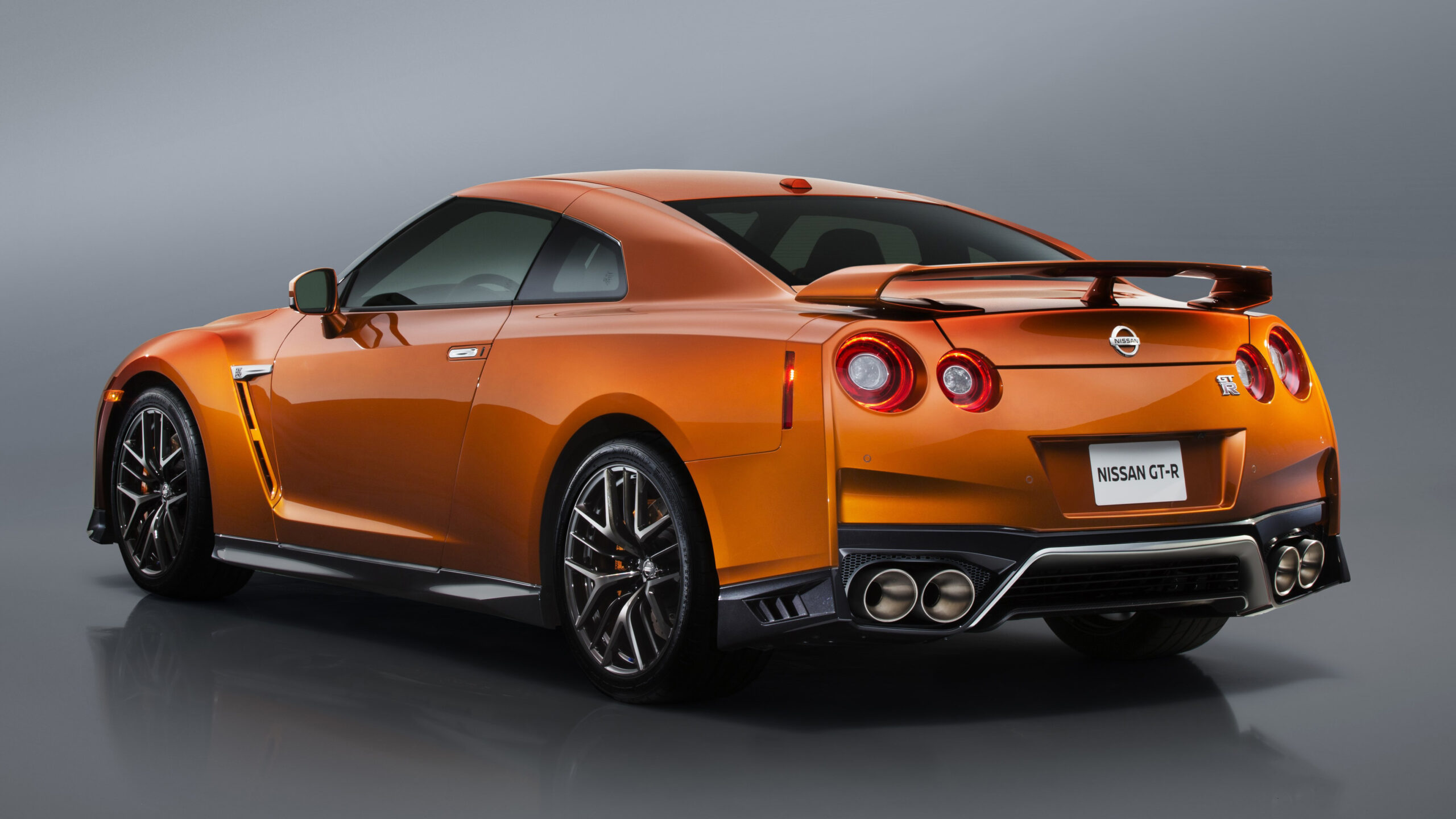 A vibrant orange Nissan GT-R, a powerful and iconic sports car, showcasing its striking design and performance prowess.