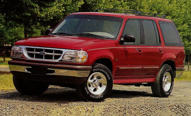 A 1996 Ford Explorer parked in a suburban neighborhood, showcasing its iconic design and distinct features.