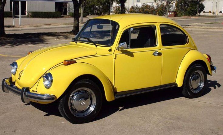 Iconic original Volkswagen Beetle, showcasing its distinctive rounded shape and compact size.