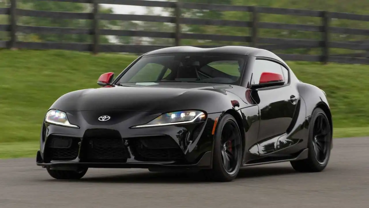 Image of a sleek black Toyota Supra, showcasing its sporty design and dynamic lines.