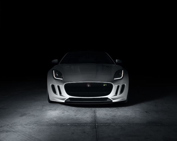 A sleek and powerful Jaguar F-Type sports car, parked under the sunlight, showcasing its striking design and bold presence.